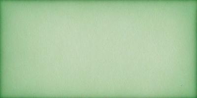 The primary subject of the image is a large, green piece of paper. The setting is a white background, which creates a clean and minimalist appearance. The visual style is a close-up of the paper, emphasizing its texture and color. The colors and mood of the image are predominantly green, giving it a calm and serene atmosphere.