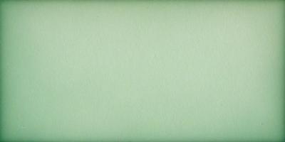 The primary subject of the image is a large, green sheet of paper. The setting is a plain, white background, and the visual style is a close-up of the paper. The colors and mood of the image are predominantly green, giving it a calm and serene atmosphere.
