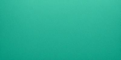 The primary subject of the image is a large, unblemished green surface. The setting is a plain, uncluttered background, which creates a sense of openness and simplicity. The visual style is a close-up of the green surface, which emphasizes its color and texture. The colors and mood of the image are predominantly green, which evokes a sense of calmness and tranquility.