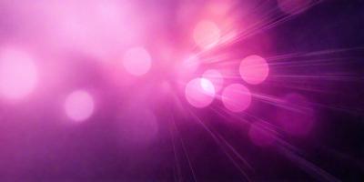 The primary subject of the image is a pink background with a purple hue. The setting is a dark background, which contrasts with the bright pink and purple colors. The visual style appears to be a digital art or illustration, as the colors and mood are vibrant and lively.