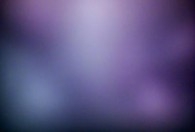 The primary subject of the image is a purple background with a blurry, out-of-focus appearance. The setting is a purple sky, and the visual style is a blend of artistic and digital elements. The colors and mood of the image are predominantly purple, creating a serene and dreamy atmosphere.