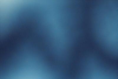 The primary subject of the image is a blue background with a pattern of white letters. The setting appears to be a dark room, and the visual style is a close-up of the blue and white pattern. The colors and mood of the image are predominantly blue and dark, creating a somewhat mysterious atmosphere.