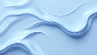 The primary subject of the image is a blue, rippled surface that resembles a wave or a flowing water. The setting is a blue background, which complements the blue color of the surface. The visual style is a digital art or illustration, as the ripples and flowing appearance are created through digital manipulation. The colors and mood of the image are predominantly blue, giving it a calm and serene atmosphere.