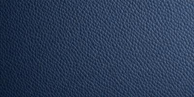The primary subject of the image is a close-up of a blue leather surface. The setting is a room with a blue leather surface, possibly a chair or a piece of furniture. The visual style is a close-up of the leather surface, which gives a sense of texture and detail. The colors and mood of the image are predominantly blue, creating a calm and soothing atmosphere.