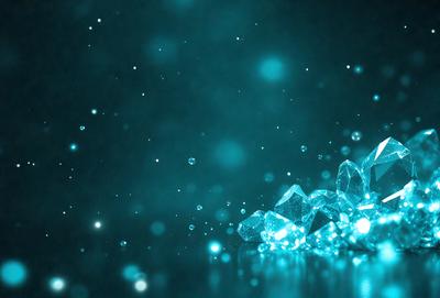 The primary subject of the image is a close-up of a blue background with a few blue crystals or glass pieces scattered across it. The setting appears to be a dark room, and the visual style is a combination of a photo and digital art. The colors and mood of the image are predominantly blue, creating a calm and serene atmosphere.