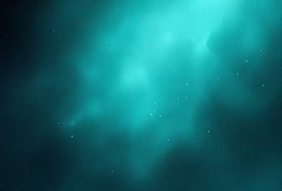 The primary subject of the image is a blue sky filled with stars. The setting is a dark, cloudy night, creating a dramatic contrast between the bright stars and the dark background. The visual style is a combination of a photo and digital art, as the image captures the beauty of the night sky with the stars. The colors and mood of the image are predominantly dark and moody, with the blue sky and stars providing a sense of depth and tranquility.