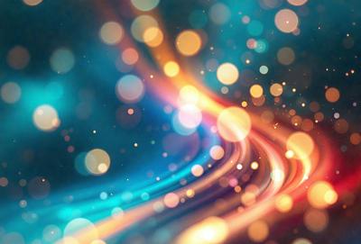 The primary subject of the image is a colorful, swirling pattern of lights. The setting is a dark background, which contrasts with the bright and vibrant colors of the lights. The visual style is a combination of digital art and illustration, creating a dynamic and eye-catching scene. The colors and mood of the image are predominantly warm and lively, with the swirling lights evoking a sense of motion and energy.
