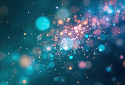 The primary subject of the image is a brightly colored, swirling pattern of lights, which creates a vibrant and lively atmosphere. The setting is a dark blue background, which contrasts with the bright lights, adding depth and visual interest to the scene. The visual style of the image is a combination of digital art and illustration, as the swirling lights are created through a digital medium. The colors and mood of the image are predominantly blue and orange, with the blue background providing a sense of calmness