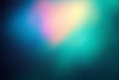 The primary subject of the image is a colorful, abstract background featuring a mix of pink, yellow, and green hues. The setting is a dark background, which contrasts with the vibrant colors of the abstract design. The visual style appears to be a combination of digital art and illustration, creating a unique and eye-catching pattern. The colors and mood of the image are lively and energetic, with the bright colors evoking a sense of joy and creativity.