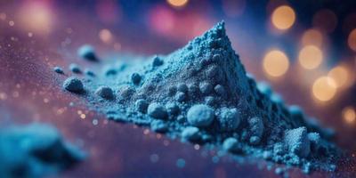 The primary subject of the image is a blue substance, possibly a powder or a blue-colored object, sitting on a surface. The setting appears to be a dark background, which contrasts with the blue substance. The visual style of the image is a close-up, focusing on the blue substance. The colors and mood of the image are predominantly blue, creating a calm and serene atmosphere.