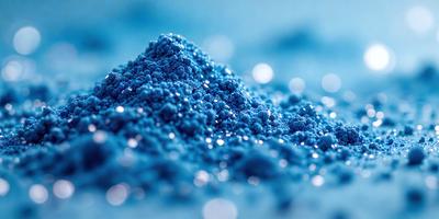 The primary subject of the image is a blue substance, possibly a powder or a liquid, with a glittery appearance. The setting is a blue background, which creates a striking contrast with the blue substance. The visual style appears to be a close-up of the blue substance, showcasing its unique texture and appearance. The colors and mood of the image are predominantly blue, giving it a calm and serene atmosphere.