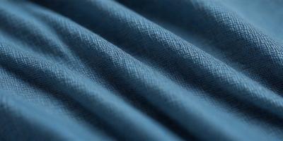 The primary subject of the image is a blue fabric, possibly a piece of cloth or a curtain. The setting is a close-up view of the fabric, showcasing its texture and pattern. The visual style is a detailed, up-close representation of the fabric. The colors and mood of the image are predominantly blue, creating a calm and serene atmosphere.
