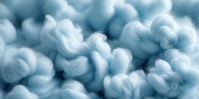 The primary subject of the image is a cloudy blue sky filled with fluffy white clouds. The setting is a vast, open sky, and the visual style is a natural, outdoor atmosphere. The colors and mood of the image are predominantly blue and white, creating a serene and peaceful ambiance.