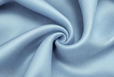 The primary subject of the image is a blue fabric, possibly a piece of cloth or a curtain. The setting is a room with a blue background, which creates a cohesive and visually appealing environment. The visual style of the image is a close-up of the blue fabric, showcasing its texture and details. The colors and mood of the image are predominantly blue, giving it a calm and serene atmosphere.