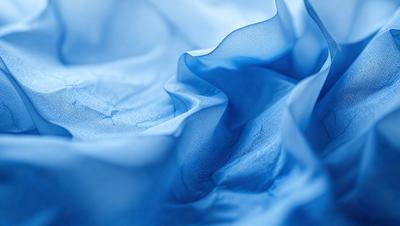 The primary subject of the image is a blue cloth, which appears to be a piece of fabric or a piece of clothing. The setting is a blue background, which complements the blue cloth. The visual style of the image is a close-up of the blue fabric, showcasing its texture and details. The colors and mood of the image are predominantly blue, creating a calm and serene atmosphere.