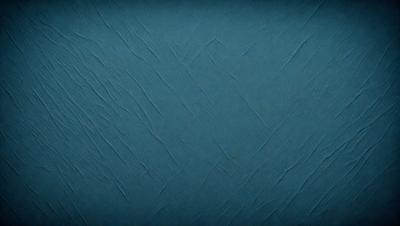 The primary subject of the image is a blue wall with a textured surface. The setting is a room with a blue wall, and the visual style is a close-up of the wall. The dominant colors are blue and grey, creating a calm and soothing atmosphere.
