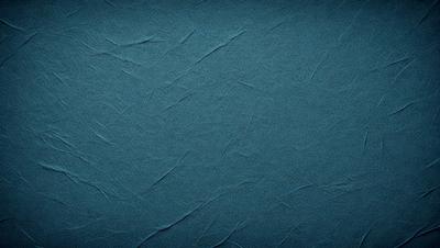 The primary subject of the image is a blue fabric with a textured surface. The setting is a blue background, and the visual style appears to be a photo. The dominant colors are blue and gray, creating a calm and soothing atmosphere.