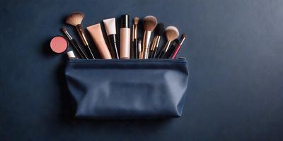The primary subject of the image is a blue makeup bag filled with various makeup brushes. The setting is a table, and the visual style is a close-up of the makeup bag. The colors and mood of the image are predominantly blue, with the blue bag and brushes creating a calm and organized atmosphere.