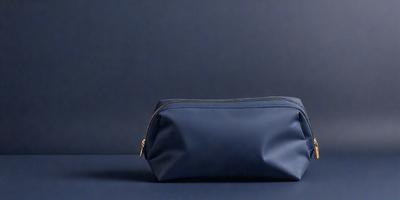 The primary subject of the image is a blue purse. The setting is a blue background, which creates a contrast with the purse. The visual style is a photo, and the colors and mood are predominantly blue, giving the image a calm and serene atmosphere.