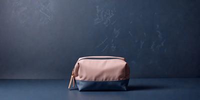 The primary subject of the image is a small pink and blue bag. The setting is a table, and the visual style is a photo. The colors and mood of the image are predominantly pink and blue, creating a calm and serene atmosphere.