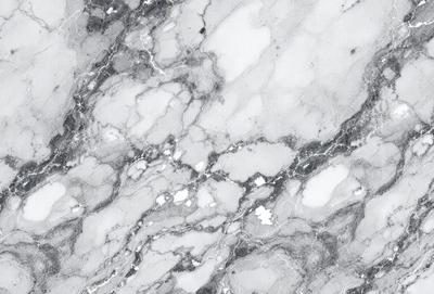 The image features a marble surface with a pattern of white and gray. The marble surface is the primary subject, and it appears to be a natural stone material. The setting is a close-up of the marble surface, showcasing its intricate patterns. The visual style is a realistic representation of the marble surface, capturing its natural beauty. The colors and mood of the image are predominantly neutral, with the white and gray tones creating a calm and sophisticated atmosphere.