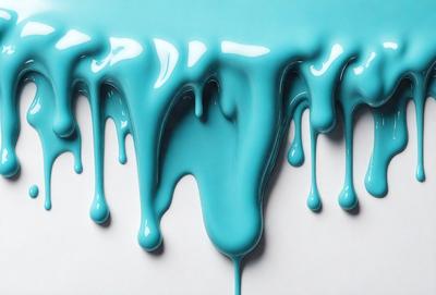 The primary subject of the image is a blue liquid, possibly a glaze or a frosting, dripping down a white surface. The setting appears to be a kitchen or a similar environment, as the liquid is dripping onto a counter or a table. The visual style of the image is a close-up of the dripping liquid, emphasizing its texture and color. The dominant colors in the image are blue and white, creating a cool and calming atmosphere.