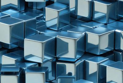 The primary subject of the image is a large number of blue and silver cubes, which are arranged in a visually appealing manner. The setting is a blue background, which provides a striking contrast to the cubes. The visual style of the image is a combination of photo and digital art, creating a unique and eye-catching pattern. The dominant colors in the image are blue and silver, giving the scene a modern and sophisticated atmosphere.