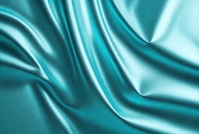 The primary subject of the image is a blue fabric, which appears to be a piece of silk. The setting is a blue background, which complements the blue fabric. The visual style is a close-up of the fabric, showcasing its texture and details. The colors and mood of the image are predominantly blue, creating a calm and serene atmosphere.