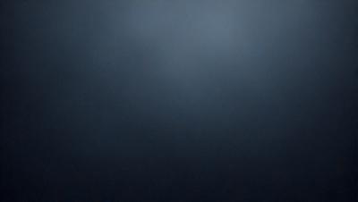The primary subject of the image is a dark blue sky. The setting is a cloudy sky, with no visible land or objects. The visual style is a photo, capturing the natural beauty of the sky. The colors and mood are predominantly dark and moody, with the blue hue creating a sense of calmness and tranquility.