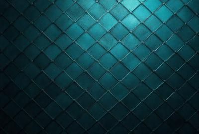 The primary subject of the image is a blue and black patterned wall. The setting is a dark room, and the visual style appears to be a photo. The dominant colors are blue and black, creating a moody atmosphere.