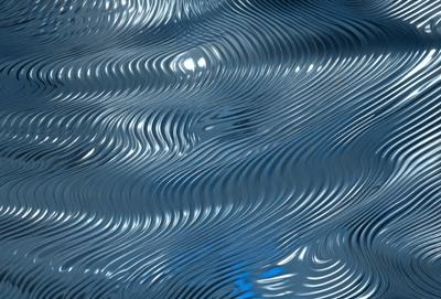 The primary subject of the image is a blue ocean with ripples and waves. The setting is the ocean, and the visual style is a photo. The dominant colors are blue and white, creating a calm and serene atmosphere.