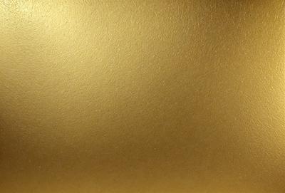The primary subject of the image is a gold wall, which is the main object, scene, or focus of the image. The setting/background is a gold wall, and the visual style is a photo. The colors and mood of the image are dominated by gold, giving it a warm and luxurious atmosphere.