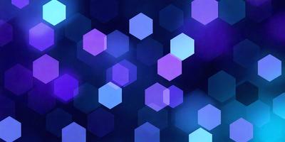The primary subject of the image is a pattern of blue hexagons. The setting is a dark blue background, which creates a contrast with the blue hexagons. The visual style is a digital art or illustration, as the hexagons are arranged in a visually appealing manner. The colors and mood of the image are predominantly blue, creating a calm and serene atmosphere.