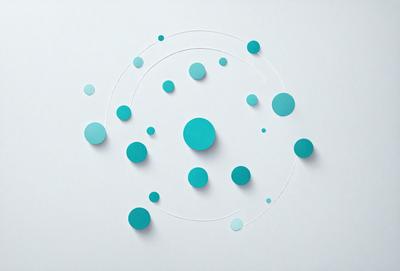 The primary subject of the image is a collection of blue and white circles arranged on a white surface. The circles are of various sizes and are placed in a circular pattern. The setting appears to be a white background, which provides a clean and minimalist appearance to the circles. The visual style of the image is a combination of digital art and illustration, as the circles are carefully placed and the overall composition is well-organized. The colors and mood of the image are predominantly blue and white, creating a sense of calmness and