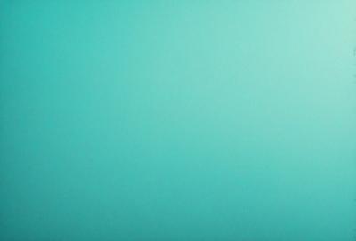 The primary subject of the image is a large, bright blue wall. The setting is a room with a blue background, which creates a vibrant and lively atmosphere. The visual style is a close-up of the blue wall, emphasizing its color and texture. The dominant colors are blue and white, with the blue wall being the most prominent feature in the scene.