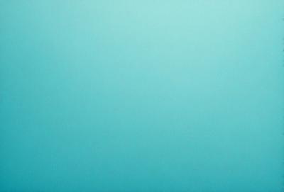 The primary subject of the image is a large, empty blue sky. The setting is a vast, open space with no visible landmarks or objects. The visual style is a natural, untouched landscape. The colors and mood are predominantly blue, creating a serene and peaceful atmosphere.