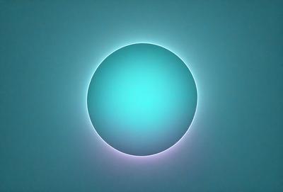The primary subject of the image is a large, brightly lit blue circle. The circle is the main focus of the image, and it appears to be floating in a dark blue background. The visual style of the image is a combination of photo and digital art, creating a unique and eye-catching effect. The dominant colors in the image are blue and purple, giving the scene a calm and serene atmosphere.