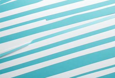 The primary subject of the image is a blue and white striped surface. The setting is a white background, and the visual style appears to be a photo. The dominant colors are blue and white, creating a calm and soothing atmosphere.