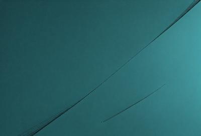 The primary subject of the image is a wire or string, which is the main object, scene, or focus of the image. The setting or background is a blue surface, which could be a wall or a piece of fabric. The visual style of the image is a close-up of the wire, which gives it a detailed and artistic appearance. The colors and mood of the image are predominantly blue, creating a calm and serene atmosphere.