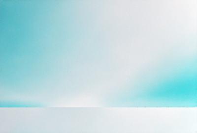 The primary subject of the image is a cloudy sky. The setting is a vast, open space with no visible landmarks or objects. The visual style is a photo, capturing the natural beauty of the cloudy sky. The colors and mood of the image are predominantly blue, creating a serene and peaceful atmosphere.