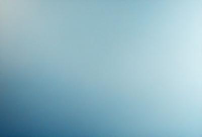 The primary subject of the image is a large, empty, and cloudless blue sky. The setting is a vast, open space with no visible landmarks or objects. The visual style is a natural, untouched, and serene environment. The colors and mood are predominantly blue, creating a sense of calmness and tranquility.