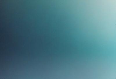 The primary subject of the image is a large, empty, and dark blue sky. The setting is a vast, open space with no visible landmarks or objects. The visual style is a natural, untouched, and unaltered representation of the sky. The colors and mood convey a sense of tranquility and vastness.