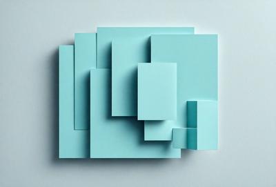 The primary subject of the image is a blue paper cut into various shapes and sizes. The paper is arranged in a visually appealing manner, creating a sense of depth and complexity. The setting is a white background, which provides a clean and minimalist appearance. The visual style is a combination of digital art and illustration, as the paper cuts are carefully crafted and arranged to create a unique and intricate design. The colors and mood of the image are predominantly blue, which adds a sense of calmness and tranqu