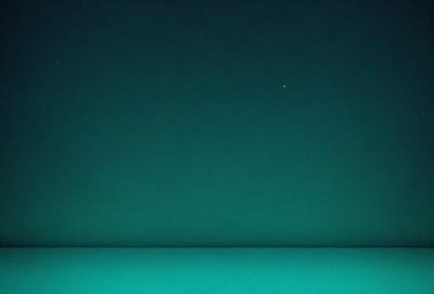 The primary subject of the image is a dark blue sky with a single star visible in the distance. The setting is a vast, open space with no other objects or elements in the frame. The visual style is a realistic representation of the night sky, and the colors and mood convey a sense of tranquility and calmness.