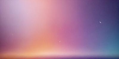 The primary subject of the image is a moon, which is the main focus of the scene. The setting is a purple sky, creating a serene and peaceful atmosphere. The visual style is a photo, capturing the beauty of the moon in the sky. The colors and mood of the image are dominated by the purple hue of the sky, which adds a sense of calmness and tranquility to the scene.