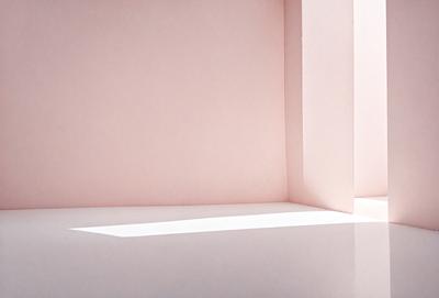 The primary subject of the image is a white wall with a pink background. The setting is a room with a white countertop. The visual style is a photo, and the colors and mood are predominantly white and pink, creating a clean and warm atmosphere.