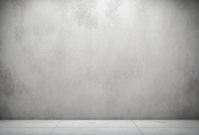 The primary subject of the image is a large, white, concrete wall. The setting is a plain, empty room with no other objects or people visible. The visual style is a photo, and the colors and mood are predominantly neutral and calm.
