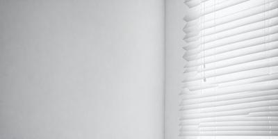 The primary subject of the image is a white wall with a window. The setting is a room with a white wall and a window. The visual style is a photo of a white wall with a window. The colors and mood are predominantly white, giving the image a clean and minimalist appearance.