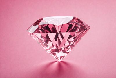 The primary subject of the image is a large, pink, cut-cornered diamond. The setting is a pink background, which creates a contrast with the diamond's color. The visual style is a close-up of the diamond, showcasing its unique shape and cut. The colors and mood of the image are predominantly pink, giving it a warm and elegant atmosphere.