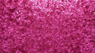 The primary subject of the image is a close-up of a pink fabric with a pattern of white hearts. The setting is a pink background, and the visual style appears to be a photo. The dominant colors are pink and white, creating a warm and inviting atmosphere.